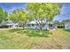 Cozy home with a well-maintained lawn and mature trees, showcasing a serene outdoor setting at 117 Bream St, Haines City, FL 33844