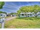 Charming home features lush front yard, mature trees, shed and a long driveway leading to the back of the property at 117 Bream St, Haines City, FL 33844