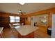 Large eat-in kitchen with a big island, stainless appliances, wood paneling, and a passthrough to another living space at 117 Bream St, Haines City, FL 33844
