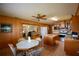 Large eat-in kitchen with wood cabinets, stainless steel appliances, an island, and a passthrough to the living area at 117 Bream St, Haines City, FL 33844