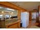 Bright eat-in kitchen with wood cabinetry, stainless appliances, an island, and a serving counter to the dining area at 117 Bream St, Haines City, FL 33844