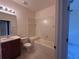 Well-lit bathroom featuring a single vanity and a combined tub and shower with tile surround at 1224 Vienna Square Dr, Winter Haven, FL 33884
