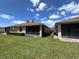 Exterior view of the backyard showcasing the screened patio and the home's backyard at 1224 Vienna Square Dr, Winter Haven, FL 33884