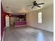 Open living area with wood floors, a ceiling fan, and seamless connection to the kitchen at 1224 Vienna Square Dr, Winter Haven, FL 33884