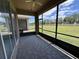 Enclosed patio with screened windows overlooking the expansive backyard at 1224 Vienna Square Dr, Winter Haven, FL 33884