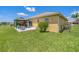 A backyard featuring a quaint gazebo with a patio, surrounded by lush green lawn and landscaping at 132 Dinner Lake Ave, Lake Wales, FL 33859