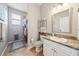 Functional bathroom with a shower stall, vanity with granite counter, and tile flooring at 132 Dinner Lake Ave, Lake Wales, FL 33859