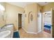 Bright bathroom features double sinks, neutral tile flooring, and decorative alcove at 132 Dinner Lake Ave, Lake Wales, FL 33859