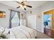 Bedroom with neutral walls, white furniture, and gray curtains at 132 Dinner Lake Ave, Lake Wales, FL 33859