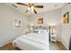Cozy bedroom featuring a ceiling fan, neutral walls, and comfortable bed with decorative pillows at 132 Dinner Lake Ave, Lake Wales, FL 33859