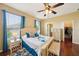 Spacious bedroom with a large window, hardwood floors, ceiling fan, and ensuite bathroom at 132 Dinner Lake Ave, Lake Wales, FL 33859