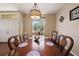 Dining room with wooden table, decorative chandelier, and a window with natural light at 132 Dinner Lake Ave, Lake Wales, FL 33859