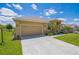Lovely single-story house with a well-maintained lawn, an attached two-car garage, and an inviting front entrance at 132 Dinner Lake Ave, Lake Wales, FL 33859
