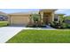 Beautiful single-story house showcasing a well-kept lawn, a two-car garage, and an inviting front entryway at 132 Dinner Lake Ave, Lake Wales, FL 33859