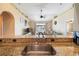 A view of the kitchen sink, granite countertop, and the living room beyond at 132 Dinner Lake Ave, Lake Wales, FL 33859