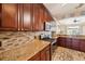 A view of the kitchen featuring custom cabinets, granite countertops and stainless steel appliances at 132 Dinner Lake Ave, Lake Wales, FL 33859