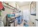 Functional laundry room with appliances, countertop, shelving, and tile flooring at 132 Dinner Lake Ave, Lake Wales, FL 33859