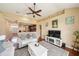 A view of the living room, showing the hardwood flooring and the kitchen beyond at 132 Dinner Lake Ave, Lake Wales, FL 33859
