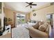 The living room with hardwood flooring, sliding glass doors to the lanai, and neutral paint at 132 Dinner Lake Ave, Lake Wales, FL 33859