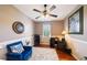 Bright office space with a comfortable blue chair, desk, and a large window at 132 Dinner Lake Ave, Lake Wales, FL 33859