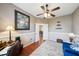 Spacious office with a view into the dining room, comfortable furniture, and natural light at 132 Dinner Lake Ave, Lake Wales, FL 33859