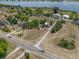 Stunning aerial view of a charming home near a serene lake and lush greenery at 134 Masterpiece Rd, Lake Wales, FL 33898