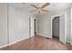 Bedroom with laminate flooring, a ceiling fan and multiple doorways at 134 Masterpiece Rd, Lake Wales, FL 33898