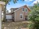 Rear exterior view of a two-story home with lawn equipment storage and access to the backyard at 134 Masterpiece Rd, Lake Wales, FL 33898