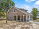 Charming brown two-story home featuring a covered carport, a swing, and a well-maintained yard at 134 Masterpiece Rd, Lake Wales, FL 33898