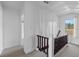 Hallway with carpet flooring and a dark wood railing at 134 Masterpiece Rd, Lake Wales, FL 33898