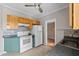Bright kitchen featuring wood cabinets, white appliances, and tile floors at 134 Masterpiece Rd, Lake Wales, FL 33898