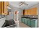 Cozy kitchen with wood cabinets, tile flooring, and good lighting at 134 Masterpiece Rd, Lake Wales, FL 33898