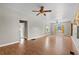 Bright and airy living room featuring laminate flooring, windows, fans, and natural light at 134 Masterpiece Rd, Lake Wales, FL 33898