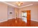 Spacious living room with hardwood floors, ceiling fan, and sliding glass doors at 135 Eloise Oaks Dr, Winter Haven, FL 33884
