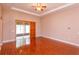 Bright and airy living room with hardwood floors, ceiling fan, and sliding doors at 135 Eloise Oaks Dr, Winter Haven, FL 33884