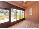 Screened-in patio with brick floors, large windows offering a lovely view of backyard at 135 Eloise Oaks Dr, Winter Haven, FL 33884