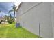 Side view of a house, highlighting the lush green lawn and a palm tree at 154 Canna Dr, Davenport, FL 33897