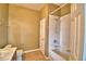 Neutral-toned bathroom showcasing a tiled shower over the tub, a toilet, and a functional design at 154 Canna Dr, Davenport, FL 33897
