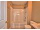 Bathroom featuring a shower-tub combo and toilet at 154 Canna Dr, Davenport, FL 33897