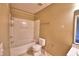 Bathroom featuring a shower-tub combo and toilet at 154 Canna Dr, Davenport, FL 33897
