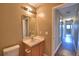 Bathroom with single vanity, mirror, and shower-tub combo at 154 Canna Dr, Davenport, FL 33897