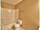 Bathroom with a bathtub shower combo, toilet and a towel rack at 154 Canna Dr, Davenport, FL 33897