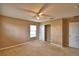 Spacious bedroom with ceiling fan, carpet floors and closet for storage at 154 Canna Dr, Davenport, FL 33897