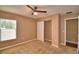 Carpeted bedroom with a ceiling fan, closet, and a window allowing natural light at 154 Canna Dr, Davenport, FL 33897