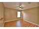 Bright bedroom features wood-look flooring, a ceiling fan, and a window for natural light at 154 Canna Dr, Davenport, FL 33897