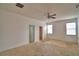 Spacious carpeted bedroom with a ceiling fan and natural light at 154 Canna Dr, Davenport, FL 33897