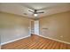 A bright bedroom features hard wood floors, ceiling fan, and neutral colored walls at 154 Canna Dr, Davenport, FL 33897