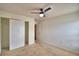 Comfortable bedroom with ceiling fan, neutral carpet, and a closet with white doors at 154 Canna Dr, Davenport, FL 33897