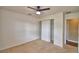 Bedroom with large closet, neutral carpet, ceiling fan, and natural light at 154 Canna Dr, Davenport, FL 33897