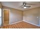 Bedroom with modern fan, wood-look flooring, and a walk-in closet at 154 Canna Dr, Davenport, FL 33897